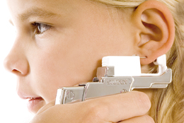 Lining up the point of the piercing earring